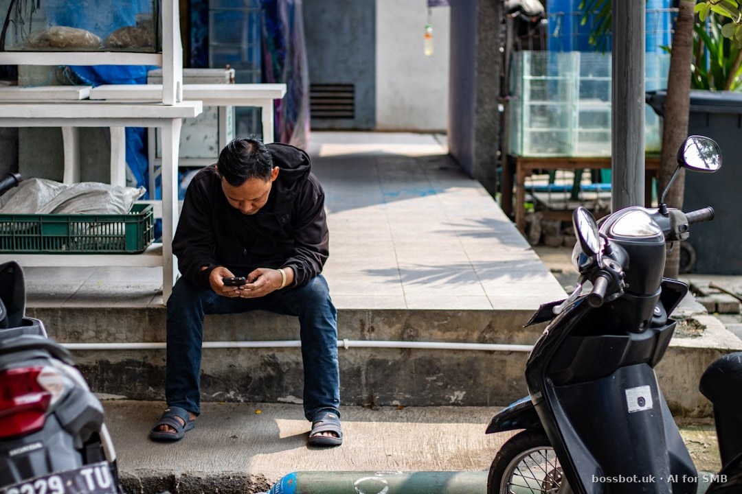 Man sitting on pavement near motorcycles