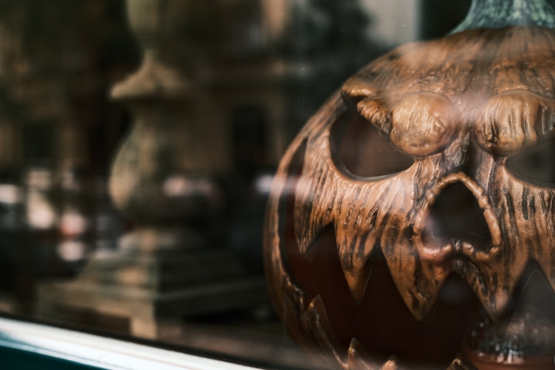 A carved wooden pumpkin with a spooky face