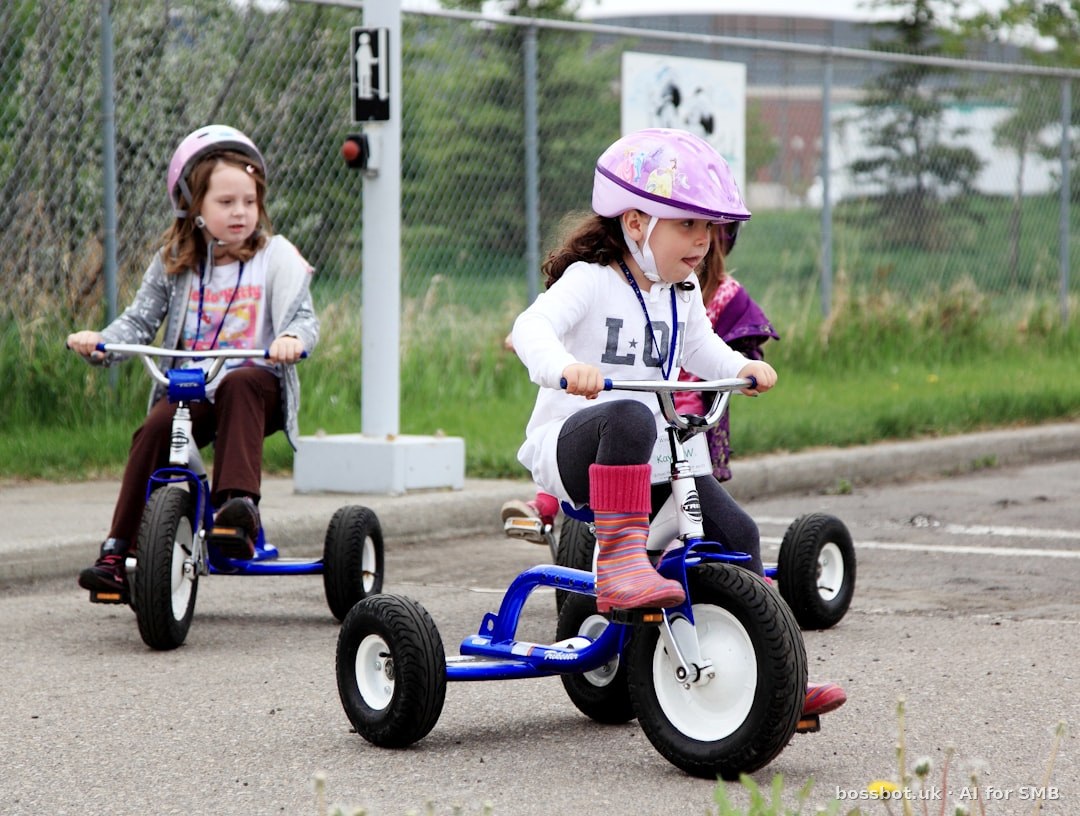 Two young girls riding tricycles outdoors