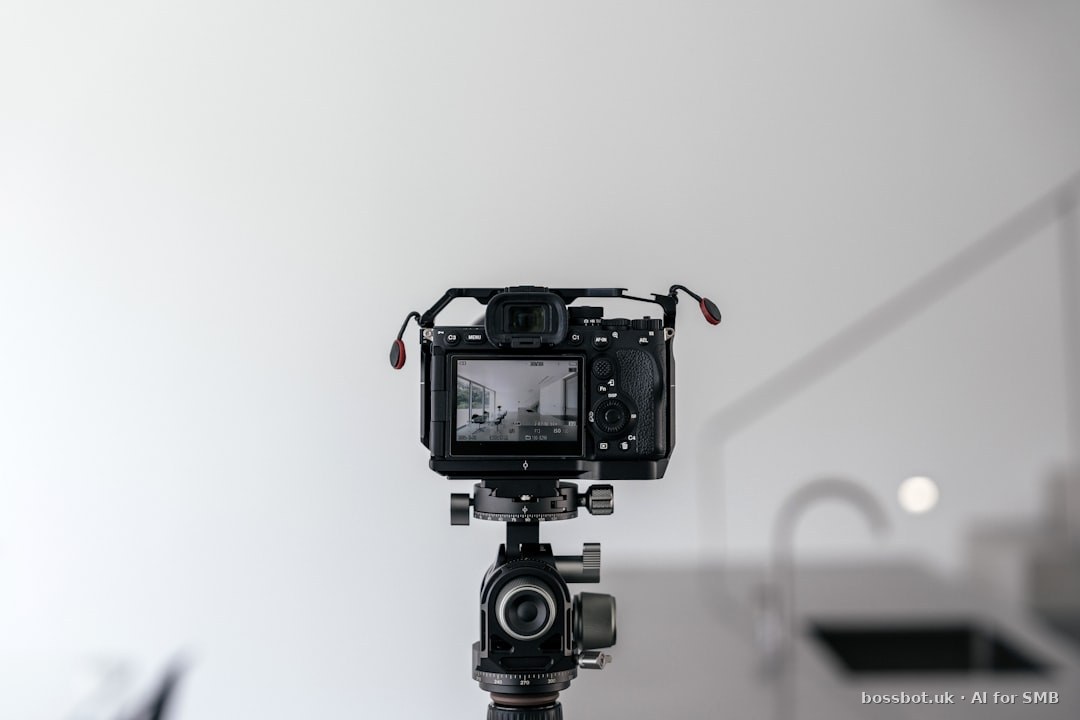 A professional photographer's studio workspace with camera and portrait prints on the wall