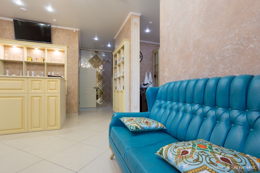 Aesthetic clinic treatment room with clinical lighting and a practitioner reviewing consultation notes on a tablet