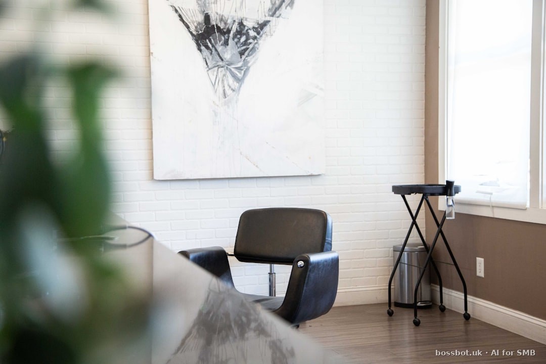 Black and gray chair beside white wall
