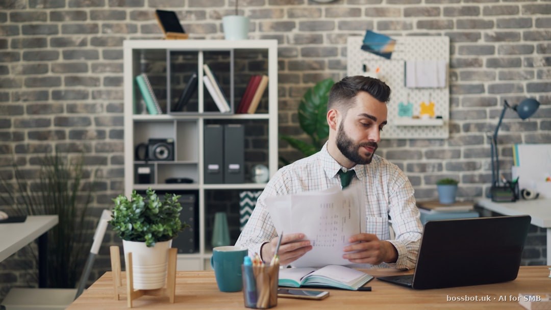 A man sitting at a desk with a laptop and papers