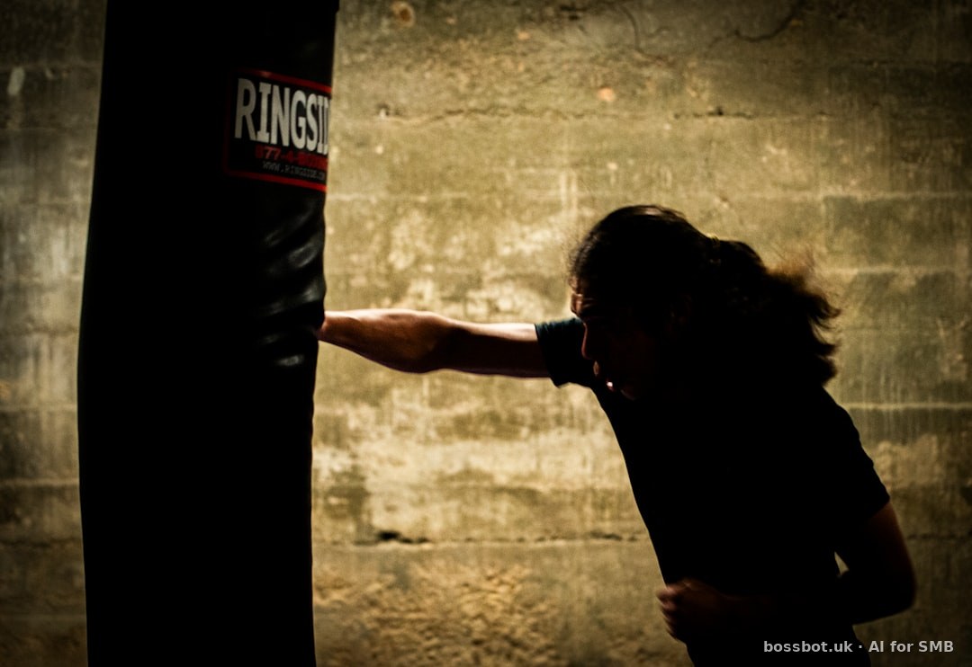A woman in a black shirt is punching a punching bag